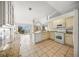Open kitchen with modern appliances, granite countertops, white cabinets, and lots of natural light at 6537 Gulf Of Mexico Dr, Longboat Key, FL 34228