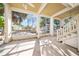 Covered patio with white pillars and stairs offering relaxing space and shade at 6537 Gulf Of Mexico Dr, Longboat Key, FL 34228