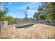 Paver patio featuring an empty pool, offering an outdoor space with potential for renovation at 6537 Gulf Of Mexico Dr, Longboat Key, FL 34228