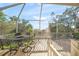 Outdoor screened in porch with seating area, offering a perfect space for relaxation at 6537 Gulf Of Mexico Dr, Longboat Key, FL 34228