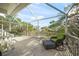 Relax on this screened porch featuring seating, a table, and beautiful views of the surrounding trees at 6537 Gulf Of Mexico Dr, Longboat Key, FL 34228