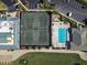 Aerial view of tennis courts and pool with lounge chairs and building at 6726 Fairview Ter # 6726, Bradenton, FL 34203