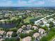Aerial view of community featuring golf course, ponds, and mature trees at 6726 Fairview Ter # 6726, Bradenton, FL 34203