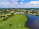 Aerial view of the community golf course and pond, showcasing the lush landscaping at 6726 Fairview Ter # 6726, Bradenton, FL 34203