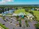 Aerial view of community clubhouse, tennis courts, swimming pool and parking area at 6726 Fairview Ter # 6726, Bradenton, FL 34203