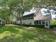Backyard view of home's screened lanai and manicured lawn at 6726 Fairview Ter # 6726, Bradenton, FL 34203