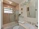 Bathroom featuring a shower/tub combination with sliding glass door at 6726 Fairview Ter # 6726, Bradenton, FL 34203