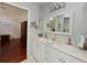 Bathroom with a double sink vanity, and a view into the main bedroom at 6726 Fairview Ter # 6726, Bradenton, FL 34203