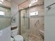 Modern bathroom features a glass shower with tiled walls and pebble flooring at 6726 Fairview Ter # 6726, Bradenton, FL 34203