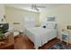 Bedroom with a ceiling fan, white shutters, and natural light at 6726 Fairview Ter # 6726, Bradenton, FL 34203