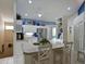Open kitchen features white cabinets, granite countertops, and a center island with seating at 6726 Fairview Ter # 6726, Bradenton, FL 34203