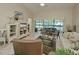 Bright living room with tile floors, ceiling fan and views of the enclosed porch at 6726 Fairview Ter # 6726, Bradenton, FL 34203