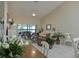 Bright living room boasts tile floors, ceiling fan and views of the enclosed porch at 6726 Fairview Ter # 6726, Bradenton, FL 34203