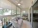 Bright sunroom features tile floors, ceiling fan, large windows, and comfortable seating at 6726 Fairview Ter # 6726, Bradenton, FL 34203