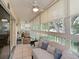 Bright sunroom features tile floors, ceiling fan, large windows, and comfortable seating at 6726 Fairview Ter # 6726, Bradenton, FL 34203