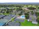 Aerial view of tennis courts, pickleball courts, swimming pool, golf course, and lush landscaping at 7061 W Country Club N Dr, Sarasota, FL 34243