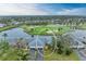 Scenic aerial view of villa with a lush golf course and tranquil lake in the backdrop at 7061 W Country Club N Dr, Sarasota, FL 34243