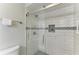 Elegant bathroom with a glass shower door, white tile, and decorative mosaic accents at 7061 W Country Club N Dr, Sarasota, FL 34243