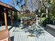 Outdoor patio features a seating area under an umbrella, providing a serene and inviting space for relaxation at 7102 Valrie Ln, Riverview, FL 33569