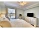 Calm bedroom with a large window, neutral tones, and ample dresser space at 8403 Grand Estuary Trl # 208, Bradenton, FL 34212