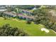 An inviting condo community view from above, nestled on a lush golf course with serene ponds at 8755 Olde Hickory Ave # 7204, Sarasota, FL 34238