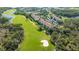 Aerial view of a condo complex situated on a golf course surrounded by lakes at 8755 Olde Hickory Ave # 7204, Sarasota, FL 34238