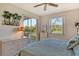 Comfortable bedroom with access to a private balcony overlooking lush greenery at 8755 Olde Hickory Ave # 7204, Sarasota, FL 34238
