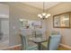 Cozy dining area with a glass table and chandelier, creating an inviting space for meals at 8755 Olde Hickory Ave # 7204, Sarasota, FL 34238