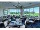 The elegant dining room provides tables and chairs with golf course views from every angle at 8755 Olde Hickory Ave # 7204, Sarasota, FL 34238