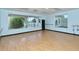 Bright exercise room with wood floors, large windows, and exercise equipment at 8755 Olde Hickory Ave # 7204, Sarasota, FL 34238