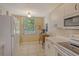 Bright kitchen features white cabinets, appliances, and a window with a view at 8755 Olde Hickory Ave # 7204, Sarasota, FL 34238