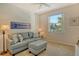 Cozy living room with a comfortable couch, ottoman, and a bright window at 8755 Olde Hickory Ave # 7204, Sarasota, FL 34238