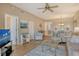 Open living room with wood flooring and lots of light, provides a clear view of the dining area at 8755 Olde Hickory Ave # 7204, Sarasota, FL 34238