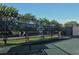 View of fenced tennis courts with the Stoneybrook Tennis logo on the wind screen at 8755 Olde Hickory Ave # 7204, Sarasota, FL 34238