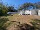 Expansive backyard with lush greenery and a charming deck, offering endless possibilities for outdoor living at 916 Michigan Ave, Palm Harbor, FL 34683