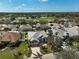 An aerial view of a beautiful neighborhood featuring a golf course, lakes, lush greenery, and well-maintained homes at 10030 Reagan Dairy Trl, Bradenton, FL 34212