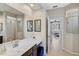 Elegant bathroom featuring dual mirrors, modern fixtures, and access to the bedroom and shower at 10030 Reagan Dairy Trl, Bradenton, FL 34212
