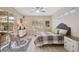 Serene bedroom with a ceiling fan, sliding glass doors, and comfortable furnishings at 10030 Reagan Dairy Trl, Bradenton, FL 34212