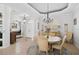 Formal dining room with elegant lighting, tray ceiling, and views of the front entrance at 10030 Reagan Dairy Trl, Bradenton, FL 34212