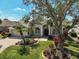 Beautiful home with meticulously manicured landscaping, mature trees, and brick-paved walkway leading to the grand entrance at 10030 Reagan Dairy Trl, Bradenton, FL 34212