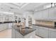 Modern kitchen with stainless steel appliances, dark countertops, a central island, and ample cabinet space for storage at 10030 Reagan Dairy Trl, Bradenton, FL 34212