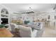 Expansive living area featuring high ceilings, an open floor plan and modern lighting, with a breakfast bar and kitchen in view at 10030 Reagan Dairy Trl, Bradenton, FL 34212