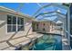 A beautiful pool is surrounded by a concrete patio, lounge furniture, and lush landscaping for outdoor relaxation at 10030 Reagan Dairy Trl, Bradenton, FL 34212