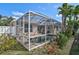 A refreshing screened-in pool surrounded by lush landscaping for outdoor relaxation and privacy in the backyard at 10030 Reagan Dairy Trl, Bradenton, FL 34212