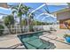 Sparkling pool with a screened enclosure offers a private and refreshing outdoor experience at 10030 Reagan Dairy Trl, Bradenton, FL 34212