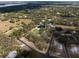 Stunning aerial view of the property showcasing lush landscaping and a beautiful lake at 1228 Wagon Wheel Dr, Sarasota, FL 34240