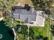 Aerial view of the well maintained home and yard next to a pond with dock at 1228 Wagon Wheel Dr, Sarasota, FL 34240
