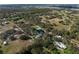 Expansive aerial view of a home with pond, mature trees and lush landscaping at 1228 Wagon Wheel Dr, Sarasota, FL 34240