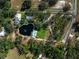 Breathtaking aerial view of a sprawling property with a large pond and inviting pool at 1228 Wagon Wheel Dr, Sarasota, FL 34240