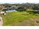 Expansive backyard featuring lush lawn, pool, and pond with fountain at 1228 Wagon Wheel Dr, Sarasota, FL 34240